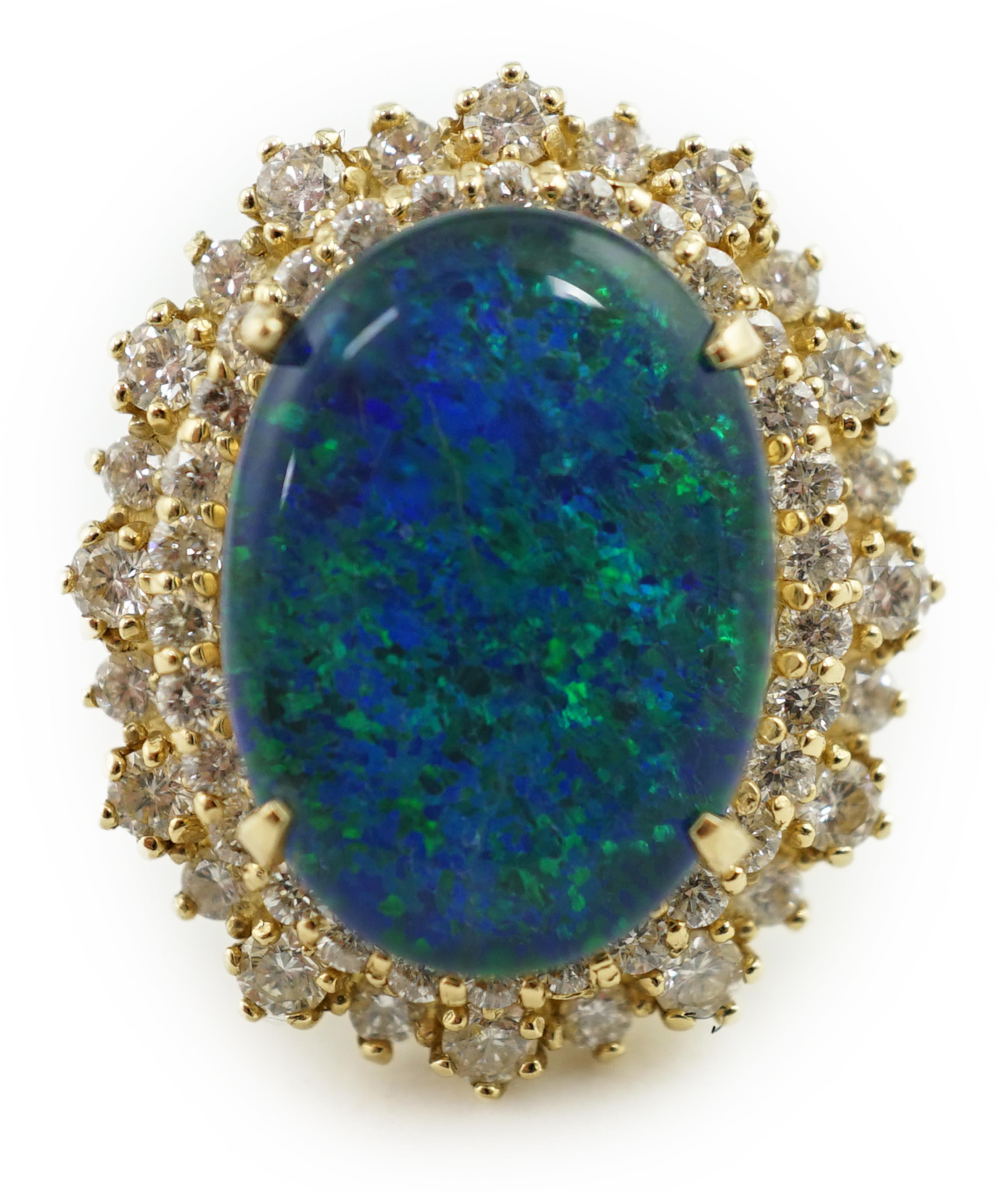 A modern American 14k gold, black opal doublet and diamond cluster set oval dress ring